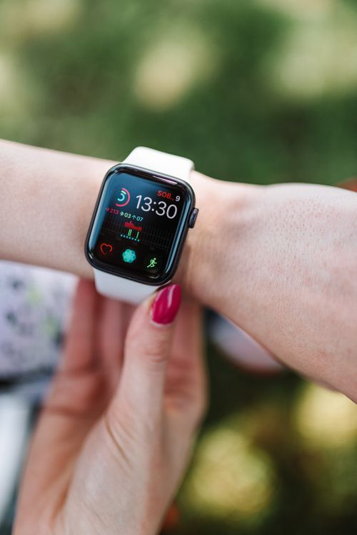 A wearable health tracker showing heart-rate data on a wrist